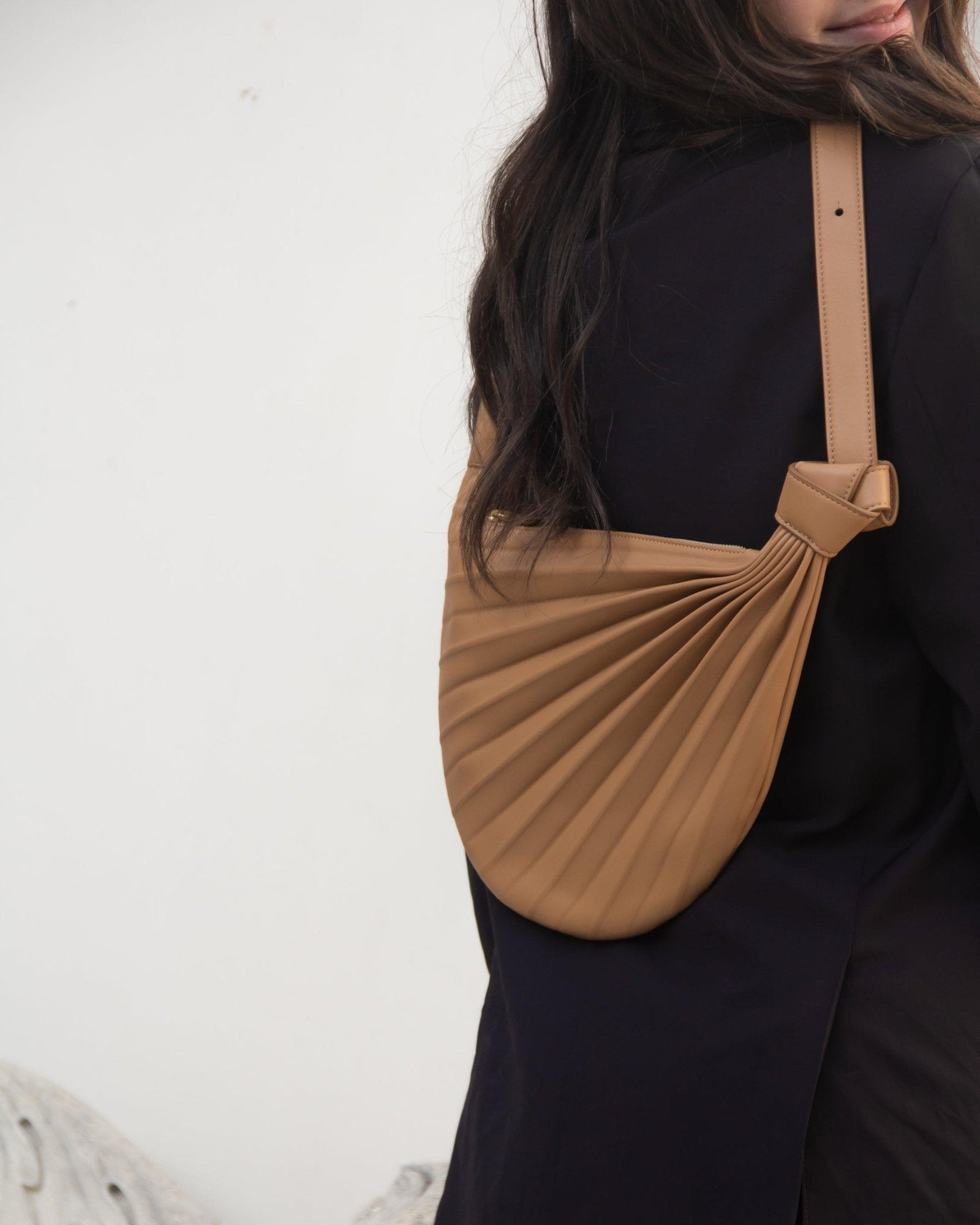 Sabrina Zeng's Chiaroscuro Hammock Sling Bag in Tan - Designer Tan Crossbody Leather Bag